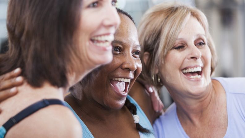 Multicultural group of three happy women in their fifties wearing exercise clothing